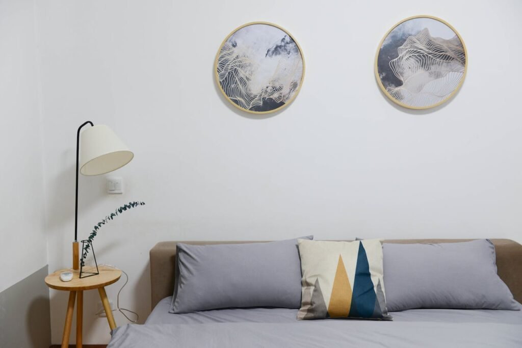 pexels-photo-707581 Beige Wooden Nightstand With White Desk Lamp; Brown Wooden Bed With Grey Comforter Set